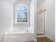 Bathroom with soaking tub, shower, and large window at 60 Legend Creek Holw, Douglasville, GA 30134