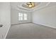 Main bedroom with tray ceiling, neutral carpet, and large window at 60 Legend Creek Holw, Douglasville, GA 30134