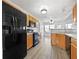 Kitchen with light wood cabinets, black appliances, and vinyl flooring at 60 Legend Creek Holw, Douglasville, GA 30134