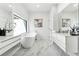 Bright, spacious bathroom with a modern soaking tub, marble floors, and sleek white cabinetry at 727 Berkeley Nw Ave, Atlanta, GA 30318