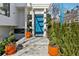 Charming front entrance with a vibrant blue door, landscaping, and modern design elements at 727 Berkeley Nw Ave, Atlanta, GA 30318