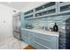 Modern kitchen with light blue cabinets, stainless steel refrigerator, light counter tops, and decorative backsplash at 727 Berkeley Nw Ave, Atlanta, GA 30318