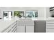 Elegant kitchen island with white farmhouse style sink, stainless steel dishwasher, and white counter tops at 727 Berkeley Nw Ave, Atlanta, GA 30318