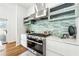 Modern gourmet kitchen featuring stainless steel appliances, light blue cabinets, and decorative backsplash at 727 Berkeley Nw Ave, Atlanta, GA 30318