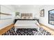 Light filled bedroom features a decorative rug, large windows, and neutral decor at 727 Berkeley Nw Ave, Atlanta, GA 30318