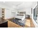 Bright bedroom features hardwood floors, modern décor, lots of light, and an ensuite bathroom at 727 Berkeley Nw Ave, Atlanta, GA 30318