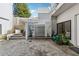 Charming patio featuring a modern water feature, lush landscaping and beautiful grey pavers at 727 Berkeley Nw Ave, Atlanta, GA 30318
