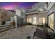 Inviting patio with stone pavers, bench, and attractive architectural water feature at twilight at 727 Berkeley Nw Ave, Atlanta, GA 30318