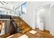 Modern staircase featuring wood treads, glass railings, and abundant natural light at 727 Berkeley Nw Ave, Atlanta, GA 30318