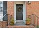 Dark wood front door accented by a wreath and potted plants at 2160 Jay Lane, Smyrna, GA 30080