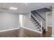 Basement with stylish carpeting on stairs, wood flooring, neutral walls, and a textured ceiling at 3847 Admiral Dr, Chamblee, GA 30341