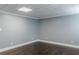 The basement area has neutral paint, beautiful dark wood flooring, and a textured ceiling at 3847 Admiral Dr, Chamblee, GA 30341