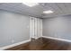 Unfinished basement showcasing dark wood flooring, neutral walls, and a textured ceiling at 3847 Admiral Dr, Chamblee, GA 30341