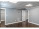 Finished basement offers dark wood floors, neutral paint, a textured ceiling and access to other rooms at 3847 Admiral Dr, Chamblee, GA 30341