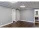 Spacious basement area with neutral paint, wood floors, and access to a bathroom with modern vanity at 3847 Admiral Dr, Chamblee, GA 30341