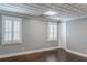 Bedroom with hardwood floors, two windows with shutters, and paneled ceiling at 3847 Admiral Dr, Chamblee, GA 30341
