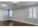 Bedroom with hardwood floors, windows with shutters, and paneled ceiling at 3847 Admiral Dr, Chamblee, GA 30341
