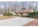 Traditional single-Gathering home featuring a large driveway and mature landscaping at 3847 Admiral Dr, Chamblee, GA 30341