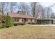 View of a single-story home featuring manicured landscaping and a charming entrance at 3847 Admiral Dr, Chamblee, GA 30341