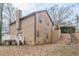 View of the rear exterior of the home with a deck and stairs leading up to the yard at 3847 Admiral Dr, Chamblee, GA 30341