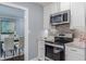 Charming kitchen featuring modern appliances and granite countertops, adjoining dining area with hardwood floors at 3847 Admiral Dr, Chamblee, GA 30341