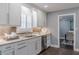 Kitchen with stainless steel dishwasher, granite countertops, and view into adjacent dining room at 3847 Admiral Dr, Chamblee, GA 30341