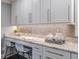 Eat-in kitchen area featuring white cabinets, granite countertops, and modern backsplash at 3847 Admiral Dr, Chamblee, GA 30341