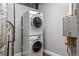 Laundry area boasts a stacked washer and dryer, plus a modern on-demand water heater at 3847 Admiral Dr, Chamblee, GA 30341