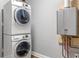 Stacked washer and dryer, plus a modern on-demand water heater in the laundry area at 3847 Admiral Dr, Chamblee, GA 30341