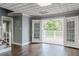 Open living room with hardwood floors and french doors to the deck at 3847 Admiral Dr, Chamblee, GA 30341