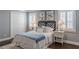 Comfortable main bedroom featuring a queen bed, hardwood floors, plantation shutters and neutral color palette at 3847 Admiral Dr, Chamblee, GA 30341
