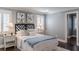 Comfortable main bedroom featuring a queen bed, hardwood floors, plantation shutters and neutral color palette at 3847 Admiral Dr, Chamblee, GA 30341