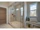 Spa-like bathroom with a large walk-in shower, built in bench, and double sinks at 3850 Ivy Cottage Se Dr, Snellville, GA 30039