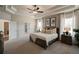 Main bedroom with tray ceiling, wooden bed frame, and a spacious layout at 3850 Ivy Cottage Se Dr, Snellville, GA 30039
