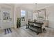 Formal dining room with a large table, bench seating, and plenty of natural light at 3850 Ivy Cottage Se Dr, Snellville, GA 30039