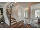 Bright entryway with hardwood floors, staircase, and views into the living areas at 3850 Ivy Cottage Se Dr, Snellville, GA 30039
