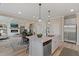 Open concept kitchen with island, stainless steel appliances, and hardwood floors at 3850 Ivy Cottage Se Dr, Snellville, GA 30039