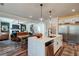 Open concept kitchen with island, stainless steel appliances, and hardwood floors at 3850 Ivy Cottage Se Dr, Snellville, GA 30039
