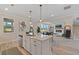 Open concept kitchen with island, stainless steel appliances, and hardwood floors at 3850 Ivy Cottage Se Dr, Snellville, GA 30039
