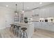 Spacious kitchen with white cabinets, a large island, and stainless steel appliances at 3850 Ivy Cottage Se Dr, Snellville, GA 30039