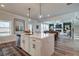 Open concept kitchen with island, stainless steel appliances, and hardwood floors at 3850 Ivy Cottage Se Dr, Snellville, GA 30039