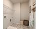 Bright laundry room with tile floors and ample shelving at 3850 Ivy Cottage Se Dr, Snellville, GA 30039