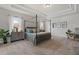 Spacious main bedroom with a four-poster bed and sitting area at 3850 Ivy Cottage Se Dr, Snellville, GA 30039