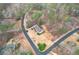 An aerial view of a landscaped home nestled amongst mature trees on a generous lot at 5216 Old Mountain Ln, Powder Springs, GA 30127