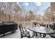 Back porch with outdoor seating and a grill, offering a great space for relaxation and social gatherings at 5216 Old Mountain Ln, Powder Springs, GA 30127