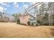 Large grassy backyard with mature trees and trimmed hedges at 5216 Old Mountain Ln, Powder Springs, GA 30127