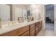 Well-lit bathroom featuring double sinks and decorative fixtures at 5216 Old Mountain Ln, Powder Springs, GA 30127