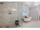 Bright bathroom featuring a clawfoot tub, glass enclosed shower, and decorative tiling at 5216 Old Mountain Ln, Powder Springs, GA 30127