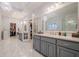 Large bathroom featuring double vanities, a glass-enclosed shower, and access to a closet at 5216 Old Mountain Ln, Powder Springs, GA 30127