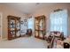 Bedroom with doll display cases, two windows, and decorative curtains at 5216 Old Mountain Ln, Powder Springs, GA 30127